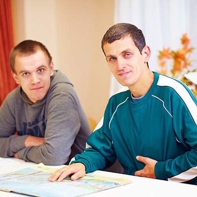 Two young men sitting together at a table